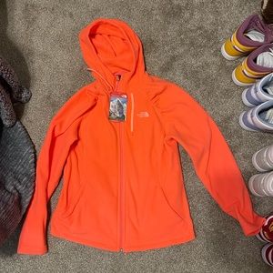 pinkish/orange north face zip up jacket